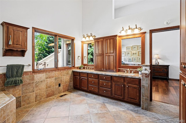5904 Meadowbrook Dr, Morrison, CO 80465 - bathroom with a towering ceiling, double vanity, and tile patterned floors