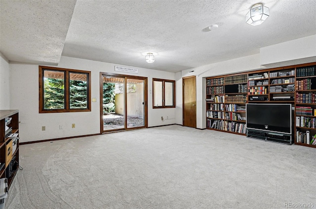 5904 Meadowbrook Dr, Morrison, CO 80465 - unfurnished living room featuring a textured ceiling, baseboards, and carpet