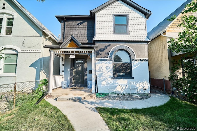 view of front of property with a front yard and fence