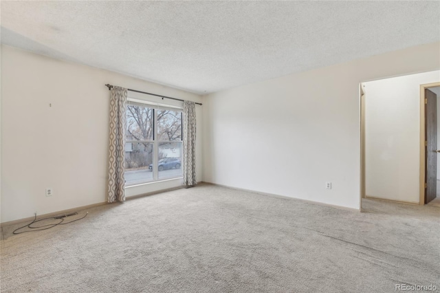 empty room with a textured ceiling and carpet