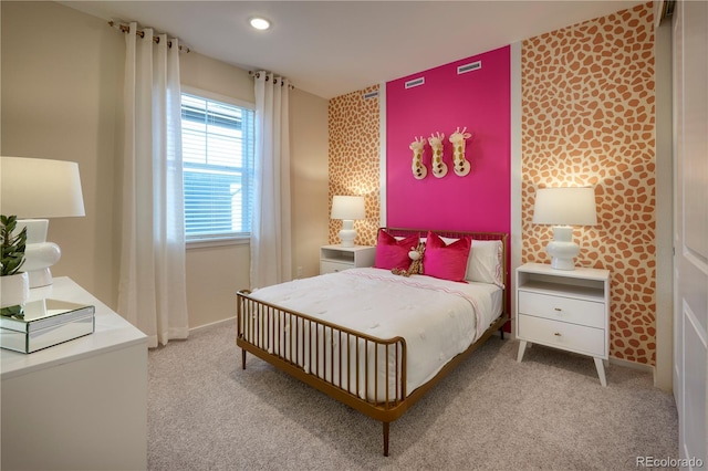 bedroom featuring recessed lighting, carpet, an accent wall, and wallpapered walls