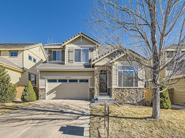 view of front of home with a garage, stone siding, a tiled roof, and concrete driveway