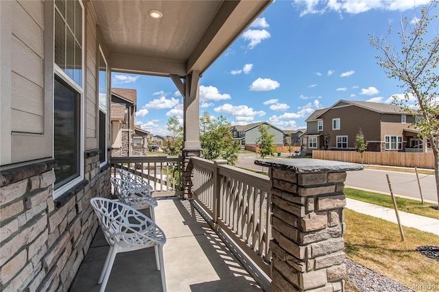 balcony featuring a residential view and covered porch
