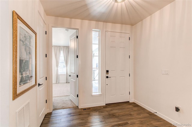 entrance foyer featuring dark wood finished floors and baseboards