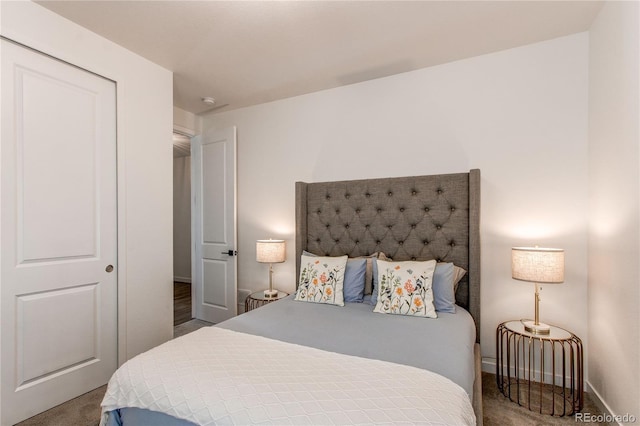 bedroom featuring carpet floors and baseboards