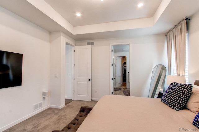 carpeted bedroom with baseboards, a tray ceiling, and recessed lighting