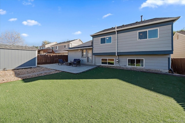 rear view of property featuring a storage unit, a lawn, and a patio area