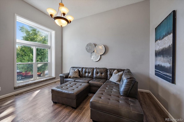 living room featuring hardwood / wood-style flooring, a chandelier, and a textured ceiling