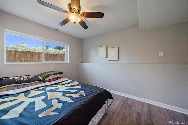 bedroom featuring ceiling fan and dark hardwood / wood-style floors