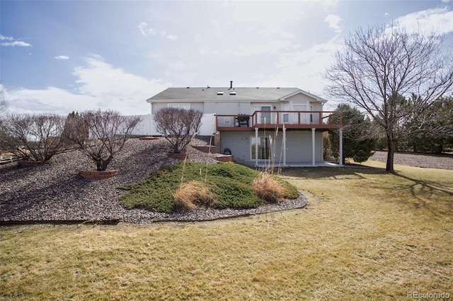 back of property featuring a deck and a lawn