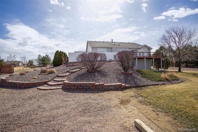 back of house featuring fence and a deck