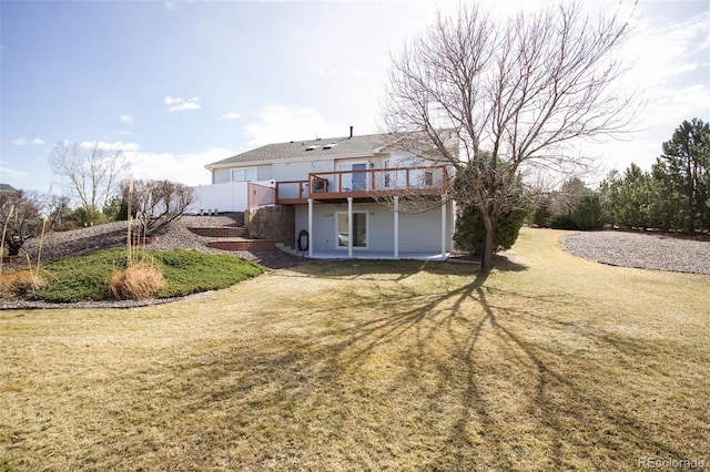 rear view of house featuring a patio area, a wooden deck, and a yard