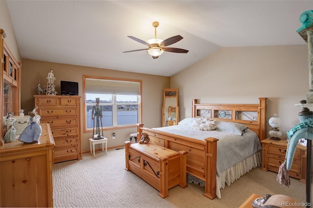 bedroom with lofted ceiling, light colored carpet, ceiling fan, and baseboards