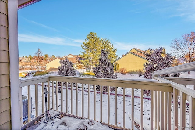 view of snow covered back of property