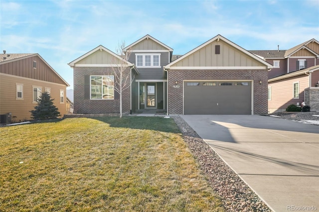 craftsman house with a front yard and a garage