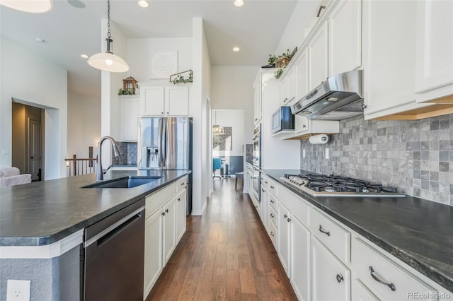 kitchen with white cabinets, decorative light fixtures, sink, and stainless steel appliances