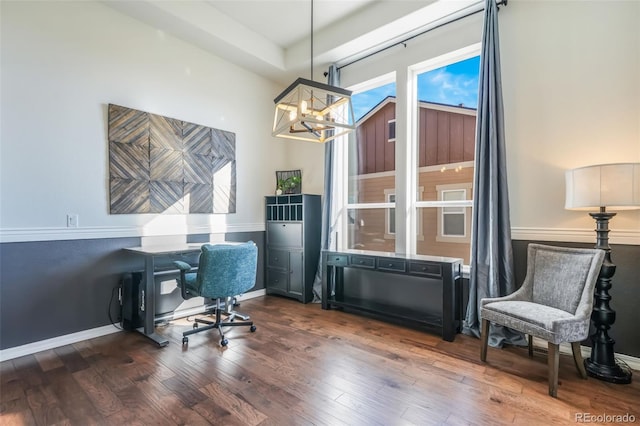 home office featuring hardwood / wood-style floors and a notable chandelier