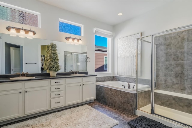 bathroom with shower with separate bathtub, vanity, and tile patterned floors