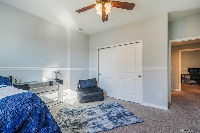 carpeted bedroom featuring ceiling fan and a closet