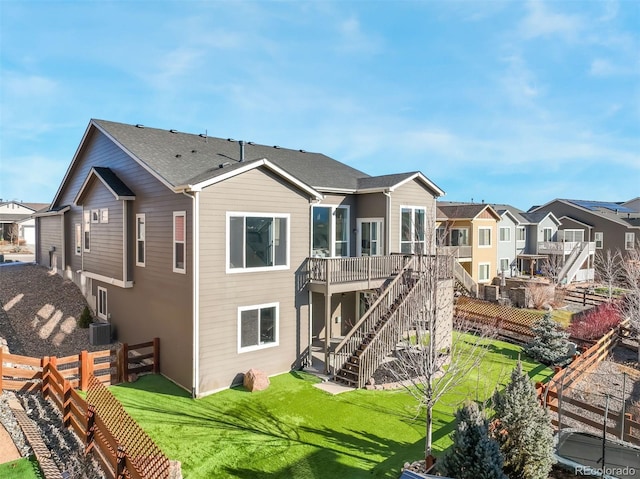 back of property featuring a lawn and central AC