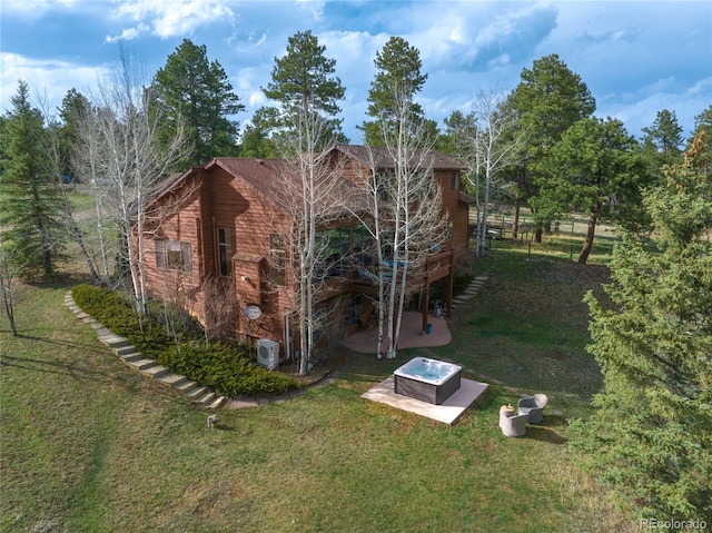view of property exterior featuring a wooden deck, a yard, and a patio