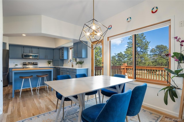 dining room featuring an inviting chandelier and light wood-style flooring