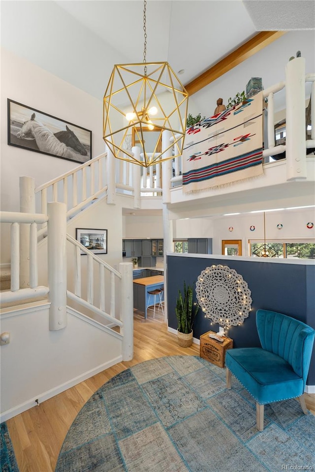 interior space featuring stairway, a notable chandelier, and wood finished floors