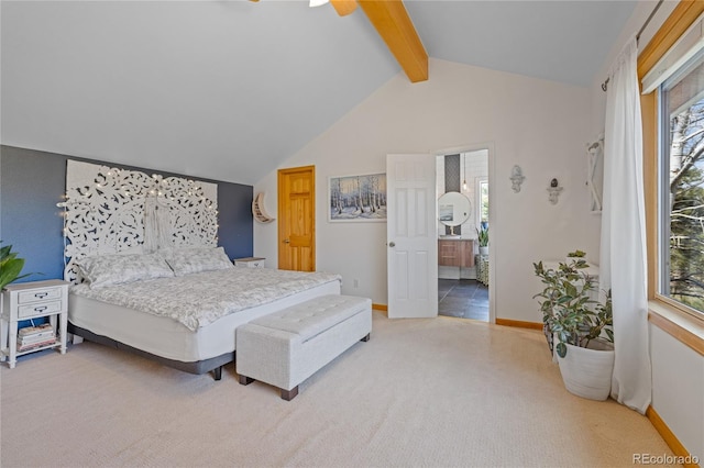carpeted bedroom with lofted ceiling with beams, ensuite bathroom, baseboards, and multiple windows
