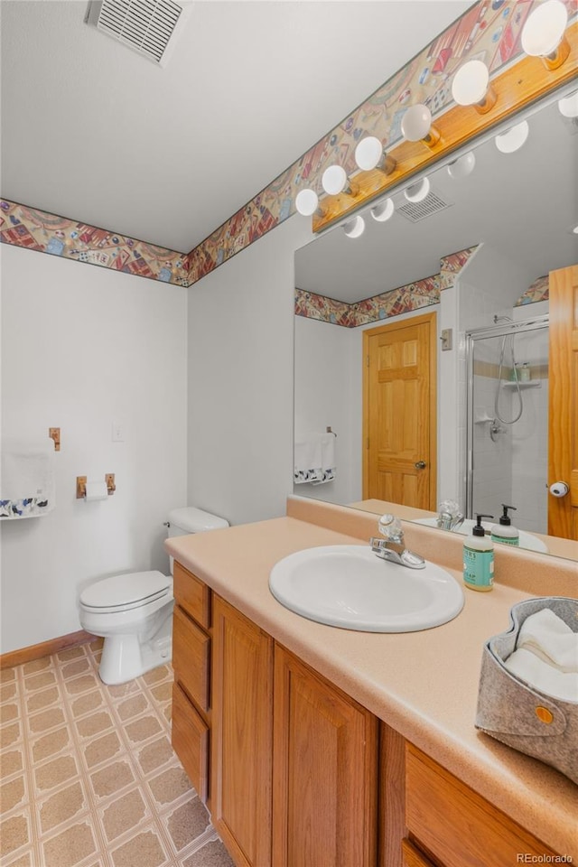 bathroom featuring a shower stall, toilet, vanity, baseboards, and visible vents