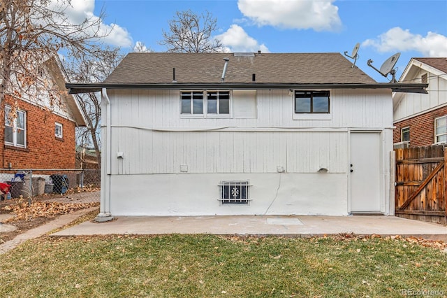 rear view of property featuring a lawn