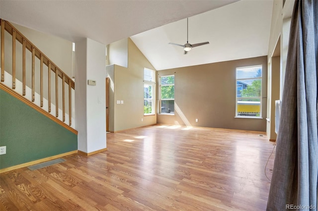 8791 Starwood Ln, Parker, CO 80134 - unfurnished living room featuring light wood-style floors, ceiling fan, stairway, and high vaulted ceiling