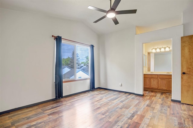 8791 Starwood Ln, Parker, CO 80134 - unfurnished bedroom featuring vaulted ceiling, light wood-style floors, connected bathroom, and a ceiling fan