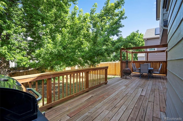 8791 Starwood Ln, Parker, CO 80134 - wooden deck featuring outdoor dining area and a fenced backyard