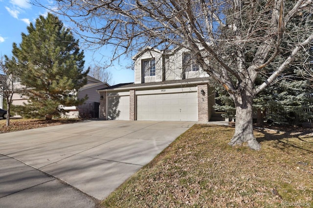 view of front of house featuring concrete driveway, brick siding, and an attached garage