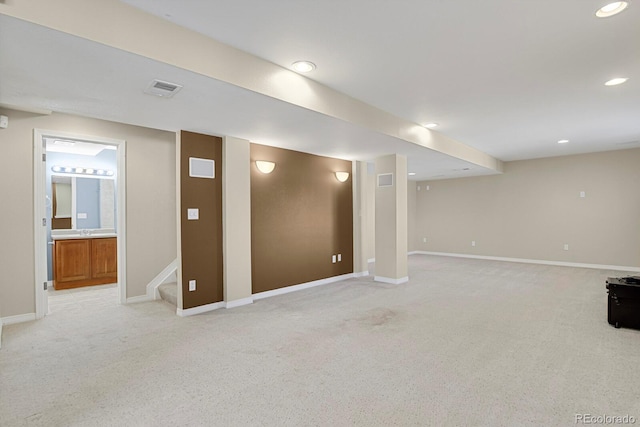 finished basement featuring recessed lighting, visible vents, light carpet, baseboards, and stairs