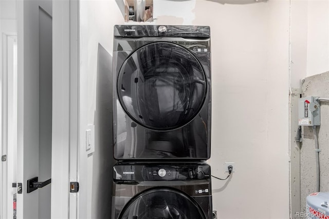 clothes washing area with stacked washer and clothes dryer