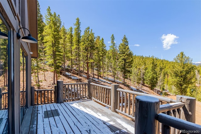 wooden deck with a forest view