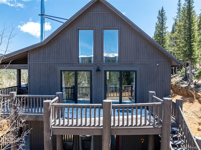 rear view of property featuring a deck