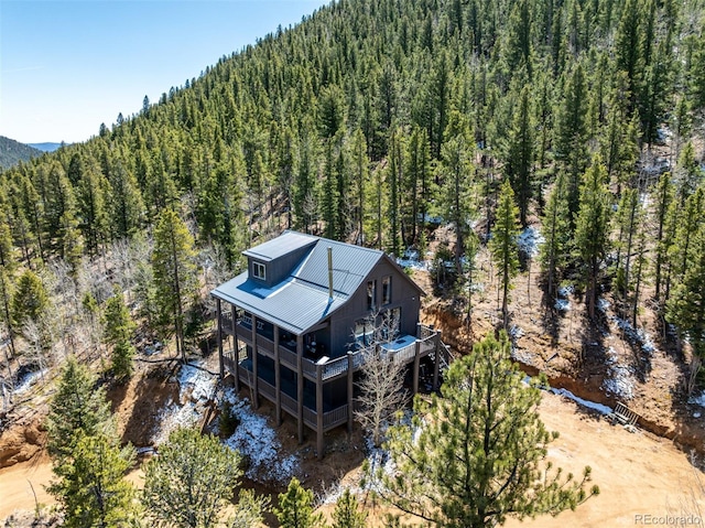 birds eye view of property with a mountain view and a forest view
