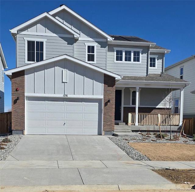 view of front of property with a porch, brick siding, and board and batten siding