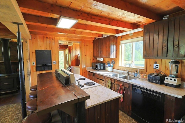 420 Quarzt Ln, Pitkin, CO 81241 - kitchen featuring black appliances, light countertops, washing machine and dryer, wood walls, and a wooden ceiling with exposed beams