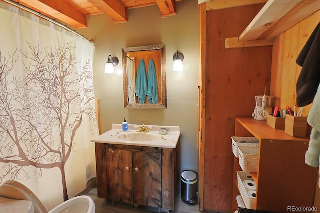 420 Quarzt Ln, Pitkin, CO 81241 - bathroom featuring vanity, beamed ceiling, a shower with shower curtain, and wood finished floors
