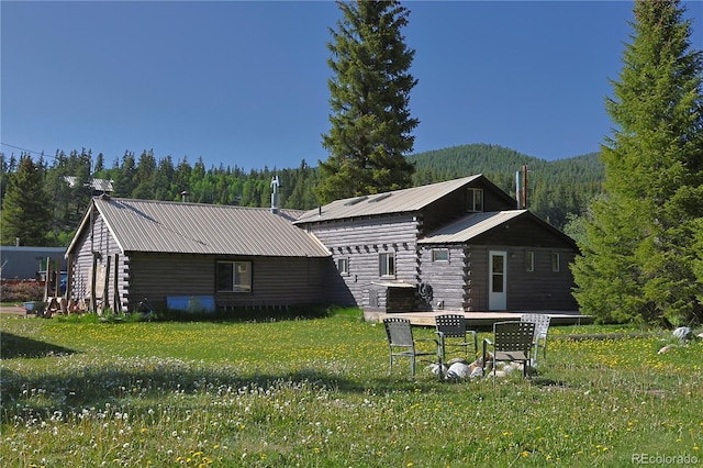 420 Quarzt Ln, Pitkin, CO 81241 - rear view of property with a metal roof, log exterior, a view of trees, and a lawn