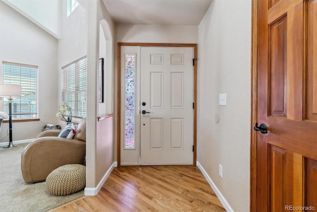 foyer entrance with light wood-type flooring and baseboards