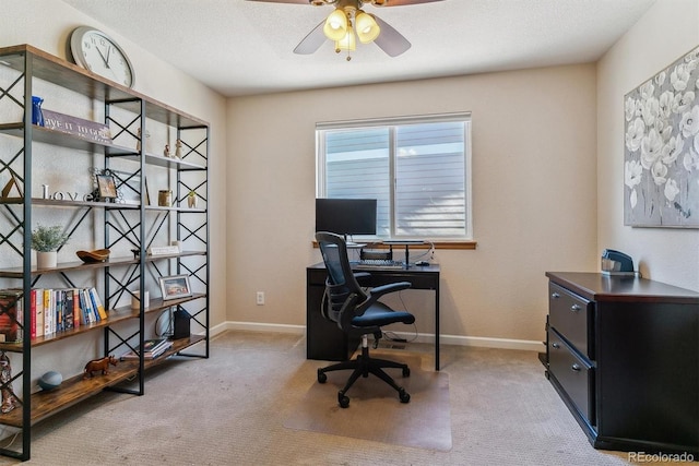 office area with carpet flooring, ceiling fan, a textured ceiling, and baseboards