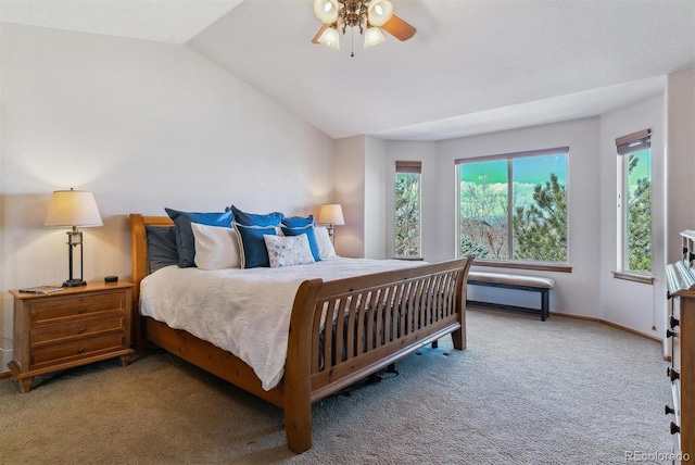 carpeted bedroom with ceiling fan, baseboards, and vaulted ceiling