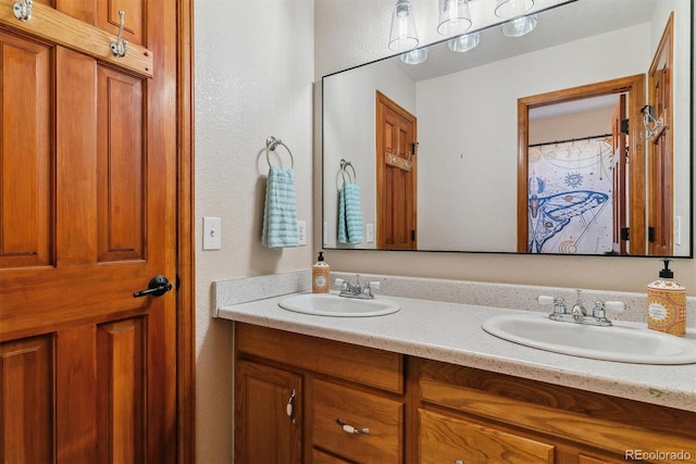 bathroom featuring a sink and double vanity