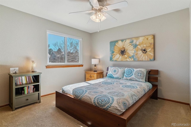 carpeted bedroom featuring ceiling fan and baseboards