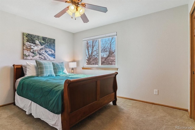 carpeted bedroom with a ceiling fan and baseboards