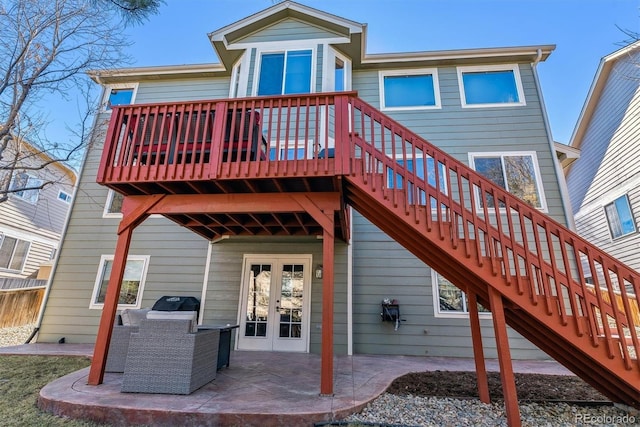 back of property with french doors, a patio area, and stairs